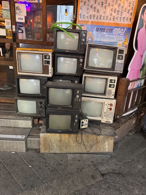 Vintage Television Collection on Seoul Sidewalk