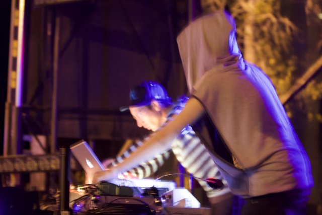 Hoodie-wearing DJ on stage