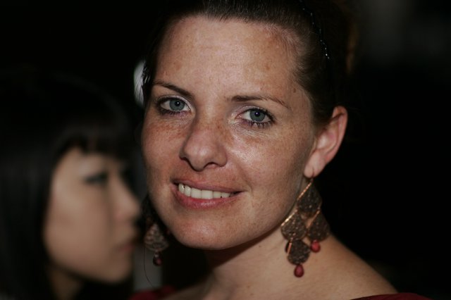 Smiling Woman with Freckles at Evening Event