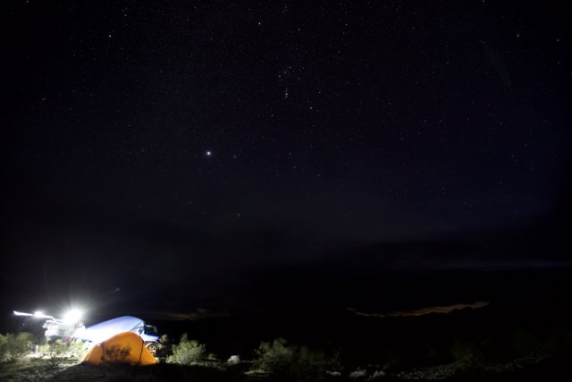 Mountain Tent Illuminated Under Starry Sky