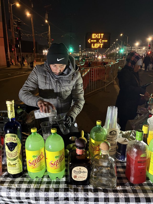 Street Bartender Mixing Drinks at Night Event