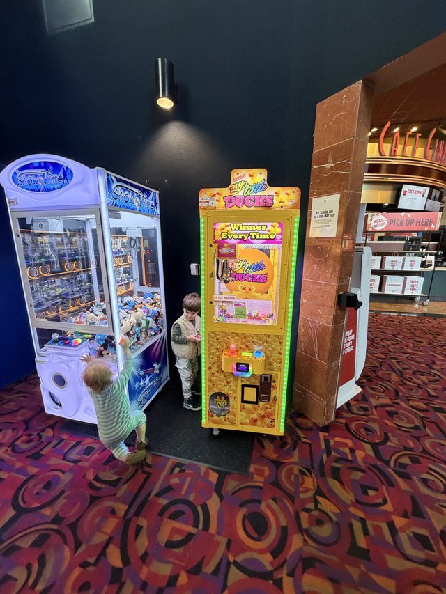 Children Playing Arcade Games at Movie Theater