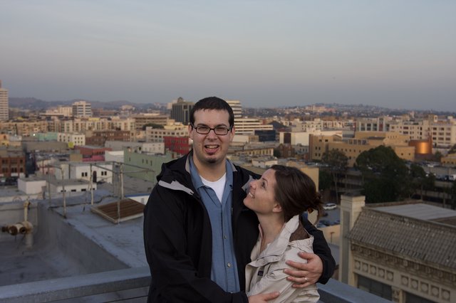 Couple Embracing on Urban Rooftop at Dusk