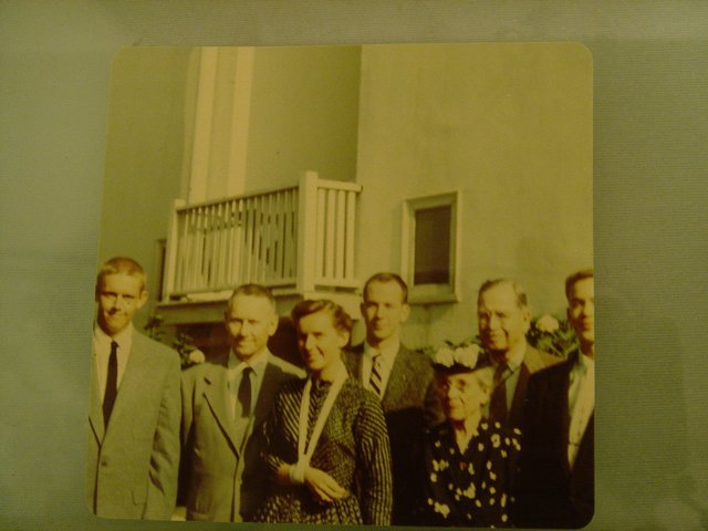 Group of People in Formal Wear Posing in Front of Building