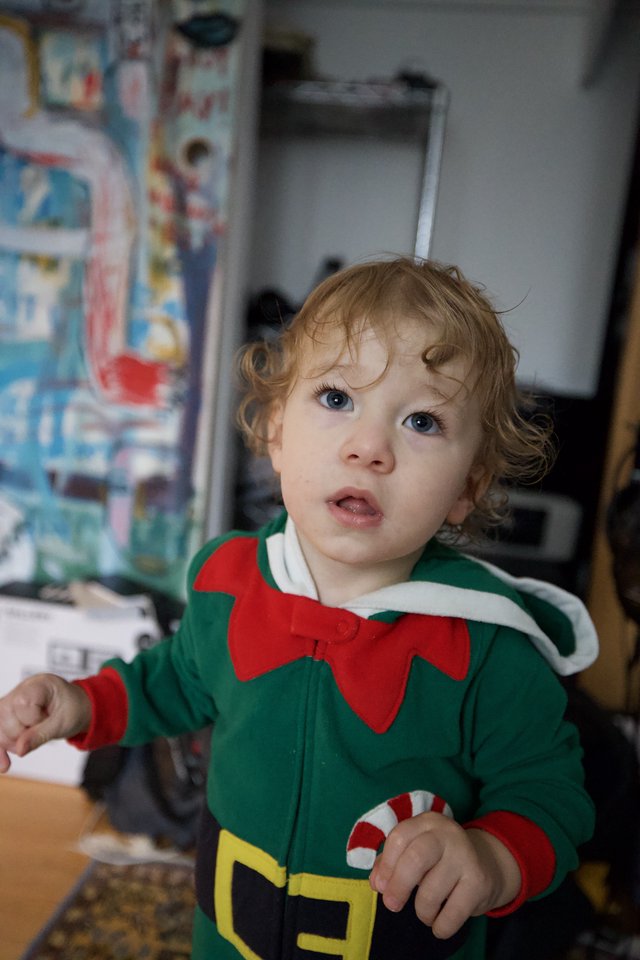 Toddler in Christmas Elf Costume at Home