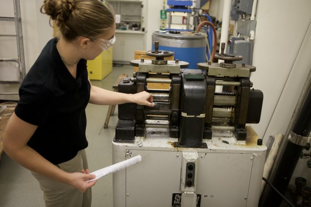 Female Engineer Working on Machine in Factory