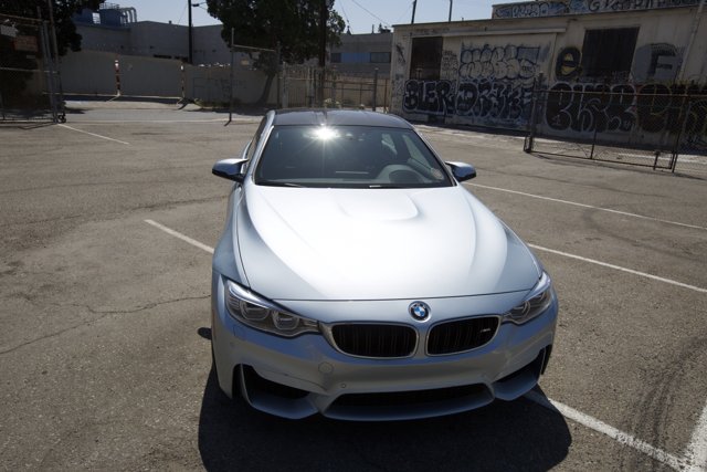 Parked BMW M4 in a Glimmering Parking Lot