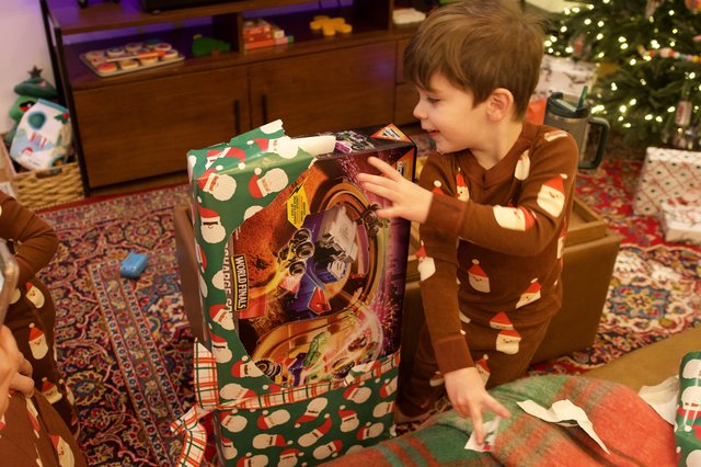 Christmas Morning Joy: Young Boy Opening Presents