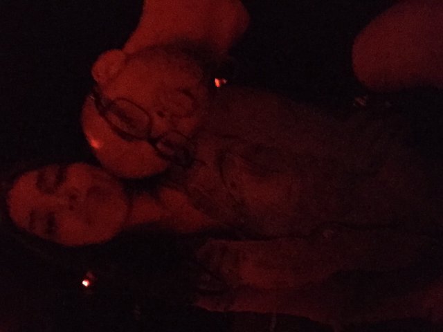 Two Friends Bathed in Red Light at Night
