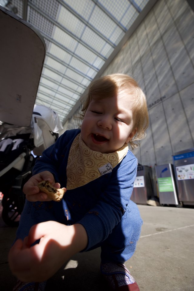 Toddler Enjoying a Snack at Transit Station