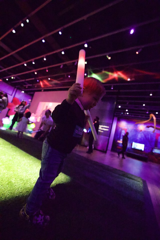 Child with LED Sword at Baby Rave Event