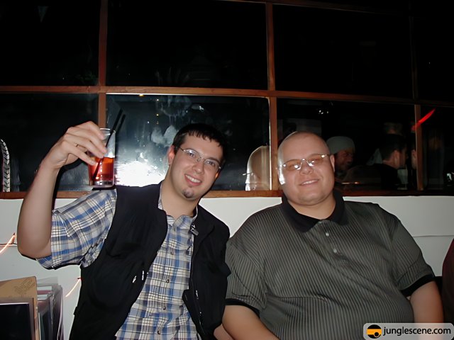 Two Men Enjoying Drinks at Urban Bar
