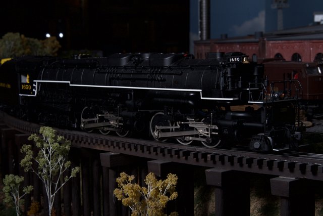 Black Locomotive Chugging Down the Tracks