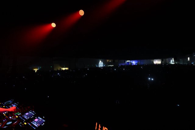 DJ Booth Perspective Over Massive Festival Crowd at Night