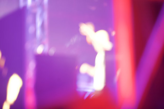 Blurry Solo Performance in Purple Spotlight