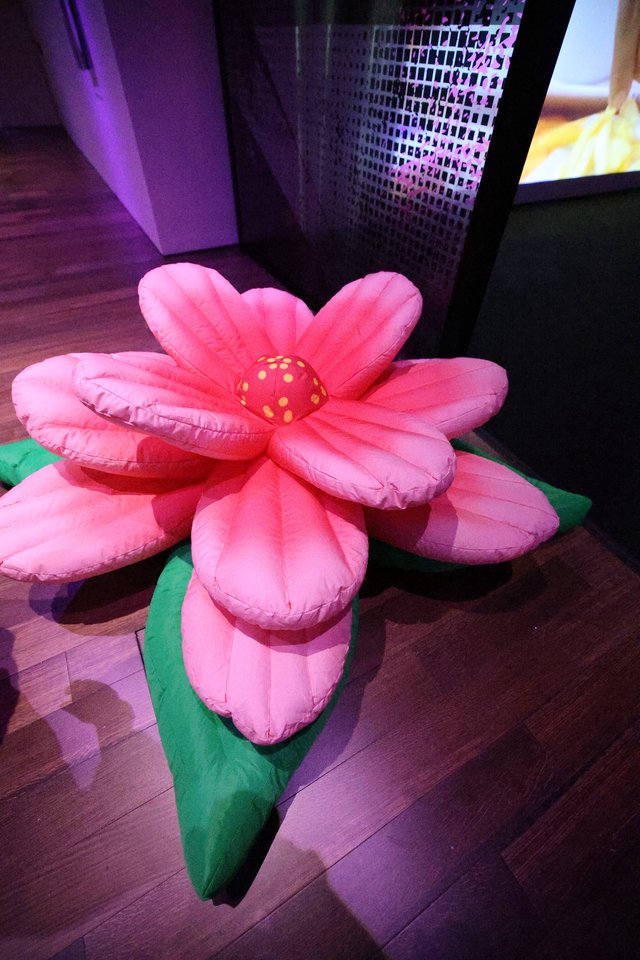 Oversized Pink Plush Flower Installation at Indoor Event