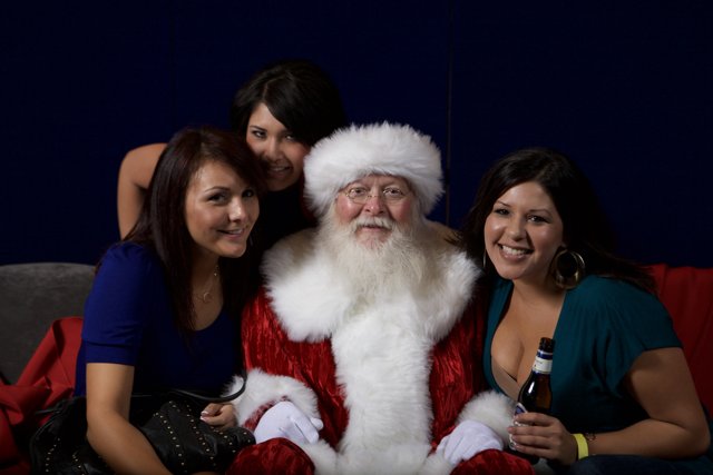 Santa Claus and Three Women Strike a Festive Pose
