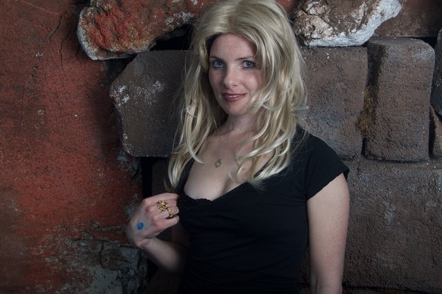 Blonde Halloween Costume Portrait Against Stone Wall