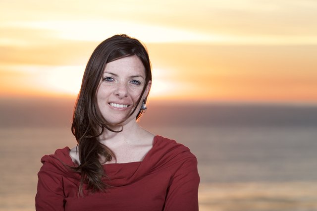 Smiling Woman at Golden Hour by the Sea