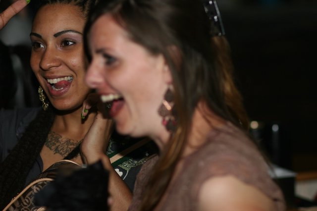 Two Women Laughing Together at Nighttime Event
