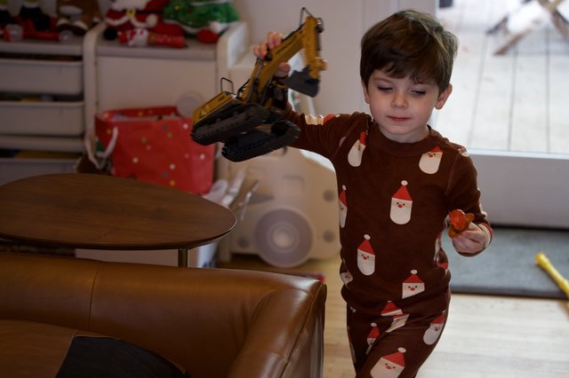Boy Playing with Toy Excavator on Christmas Eve