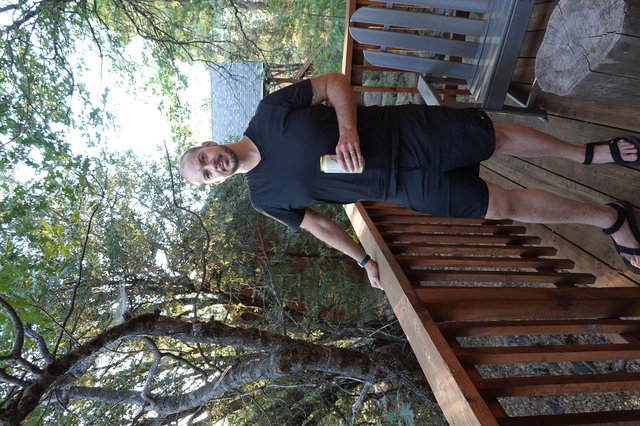 Man Enjoying Morning Coffee on Wooden Deck