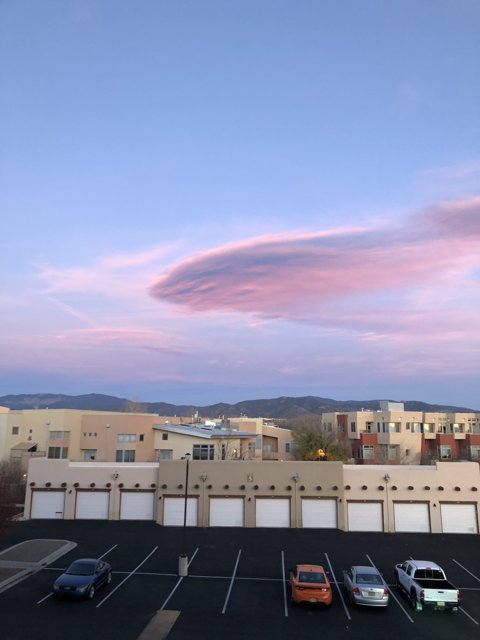 Pink Clouds Above a Busy Parking Lot