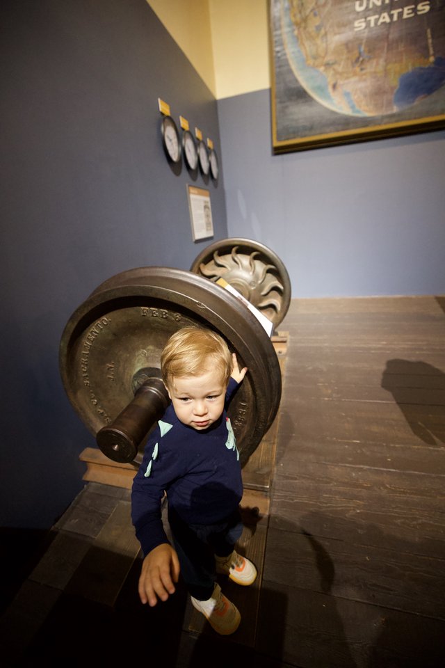 Toddler Exploring Vintage Naval Cannon at Museum