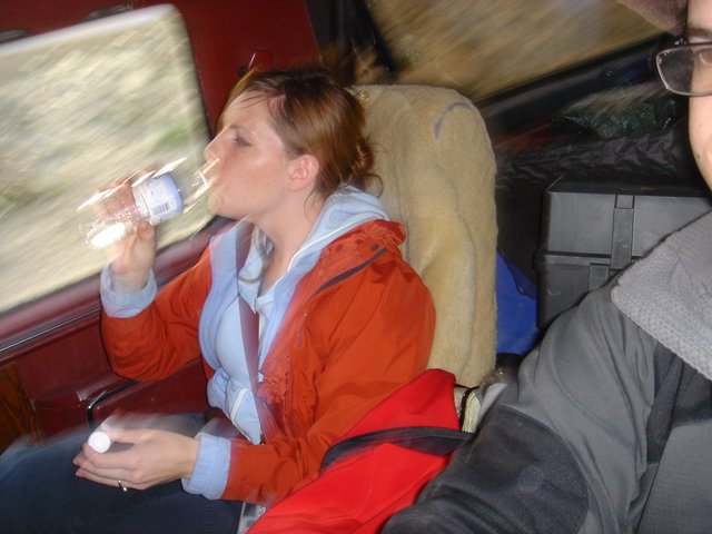 Woman Drinking Water on a Moving Train