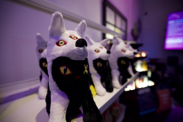 Plush Wolf Characters Display in Purple-Lit Room