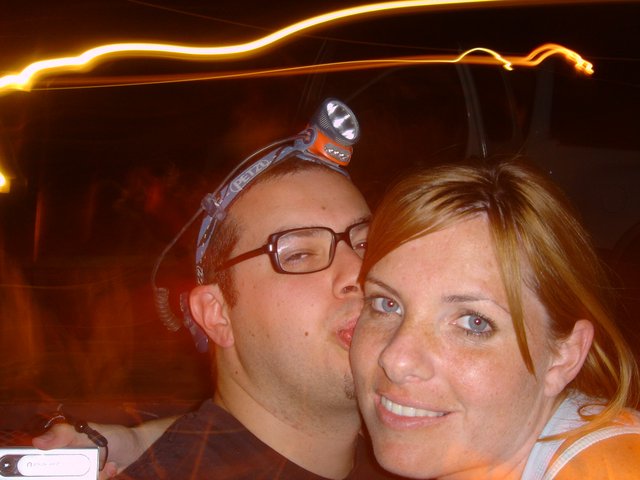 Couple Shares a Kiss at Night Outdoor Event