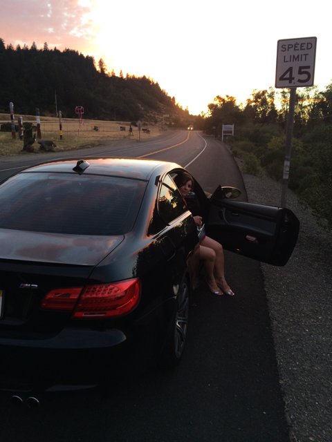 Sunset Sits with Theresa Andersson on the Hood of Her Sports Car