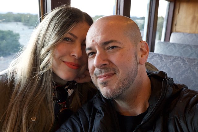 Couple's Romantic Train Journey Through Scenic Landscape