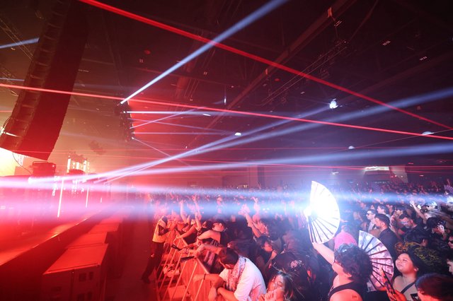 Laser Light Storm Over Pulsing Festival Crowd