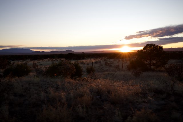 Desert Sunset Over Distant Mountain Range