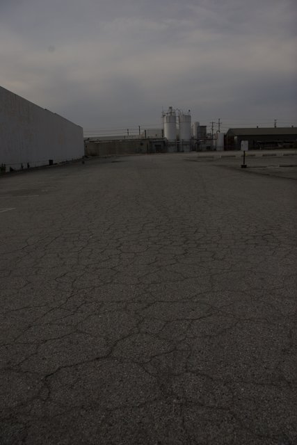 Desolate Lot with Factory in the Distance