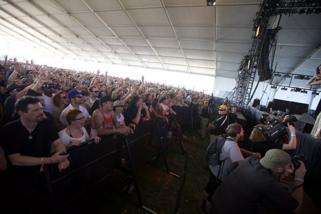 Concertgoers Raise Hands High in the Air