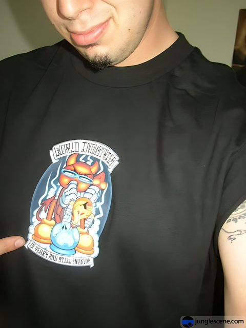 Tattooed man showing off cartoon t-shirt