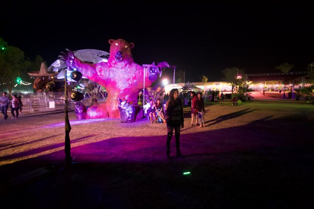 Nighttime Gathering Around Giant Pink Bear
