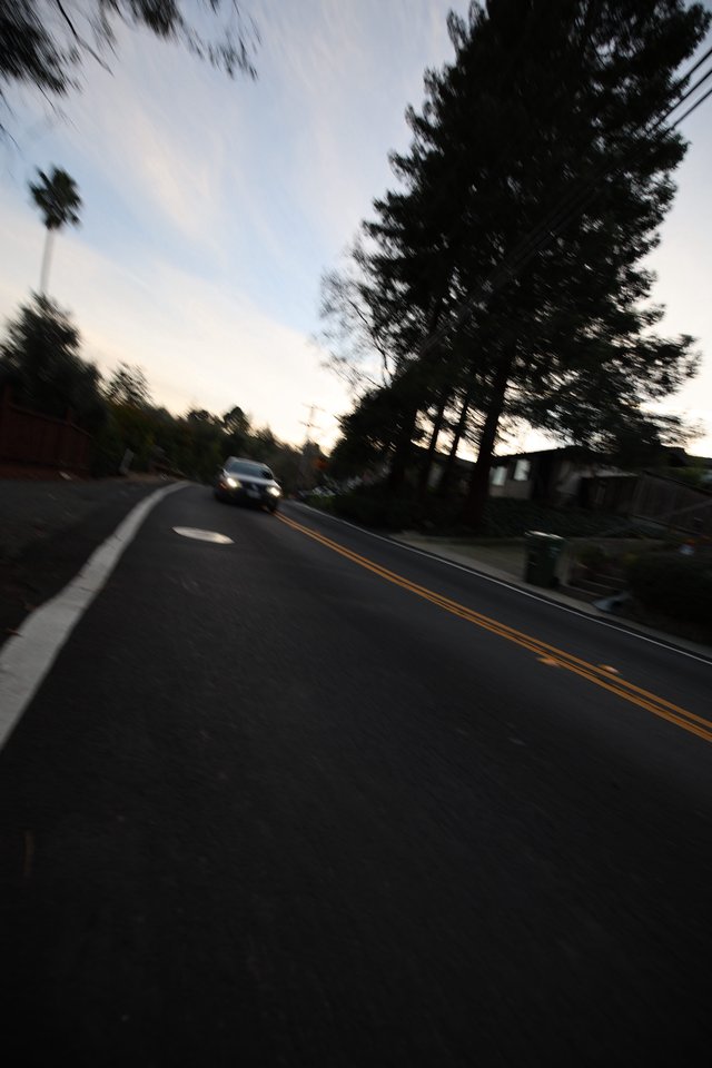 Blurred Evening Road Through Residential Neighborhood