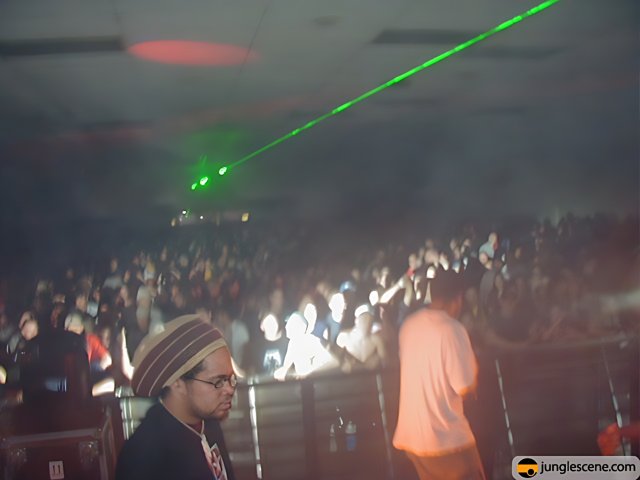 Green Laser Lights Illuminate the Crowded Nightclub