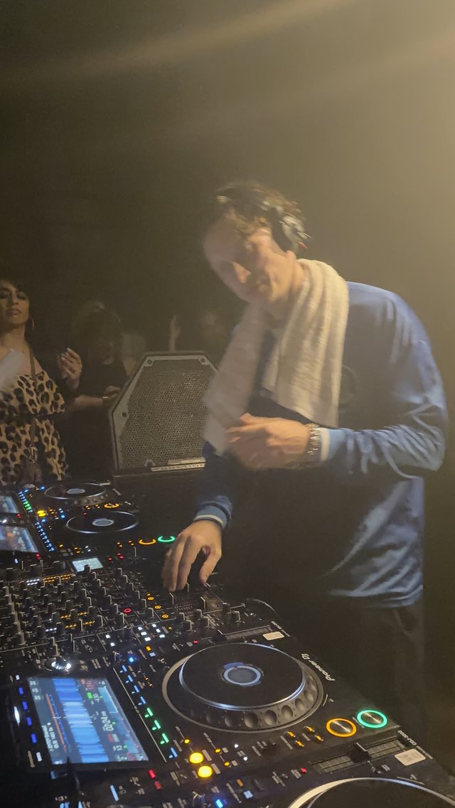 DJ Performance in Atmospheric Club Setting