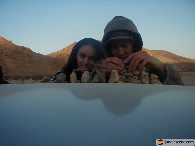 Sitting on the Hood of a Car in the Desert