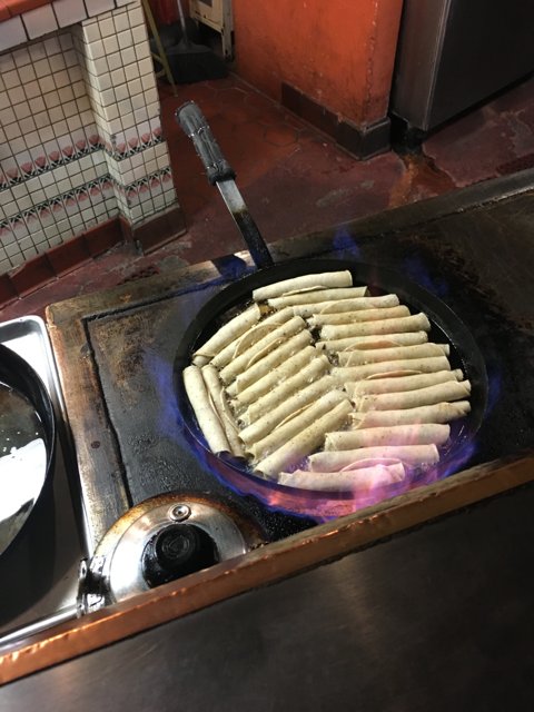Hot Dogs on a sizzling Cooking Pan