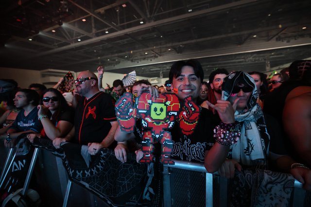 Smiling Fan Holds Pixel Art Figure at Wobbleland 2026