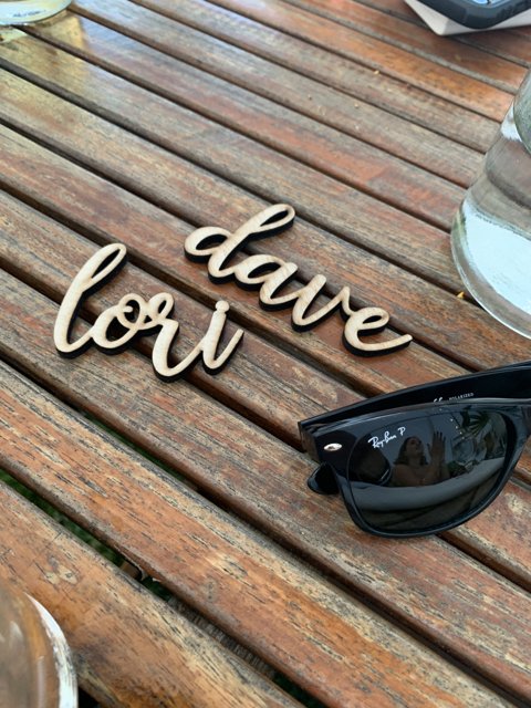 Dave Lorim's Stylish Sunglasses on a Wooden Table