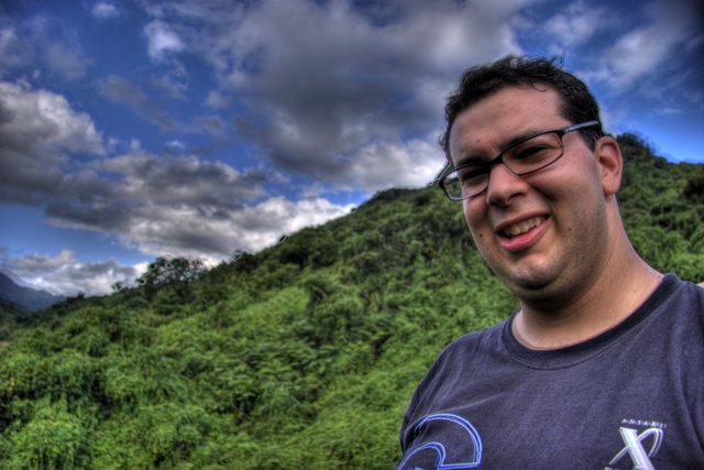 Smiling Man with Glasses in front of Majestic Mountain