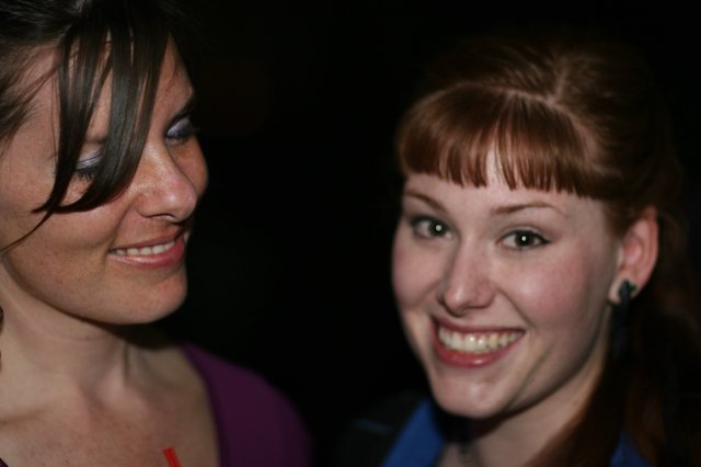Two Young Women Smiling at a Nighttime Event