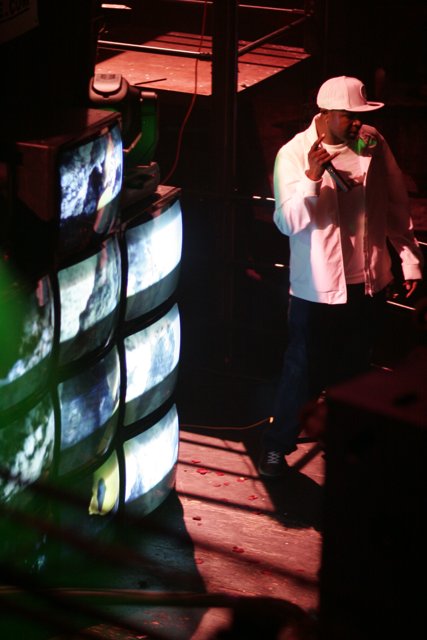 Alexei Bell performing on stage with a monitor