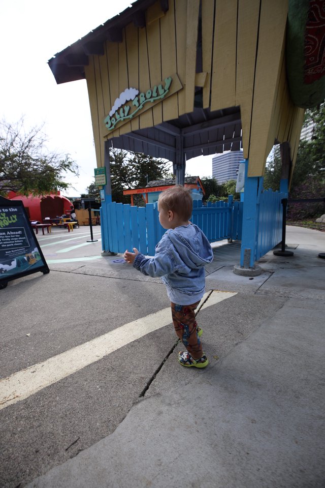 Young Child Exploring Jollity Hall Entrance at Theme Park
